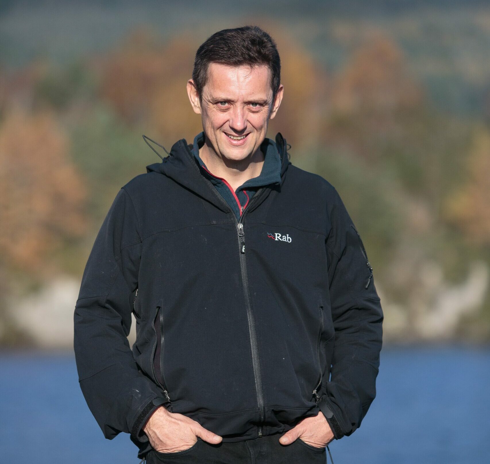 Alan Clayton in front of a blurred Loch Ness and hillside