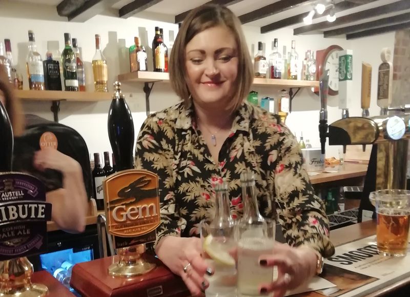 Bar staff at a pub picking up up drinks