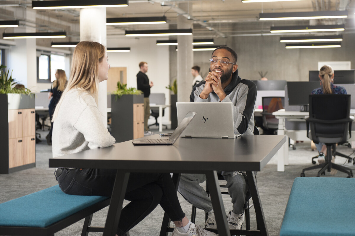 two people chat in an office