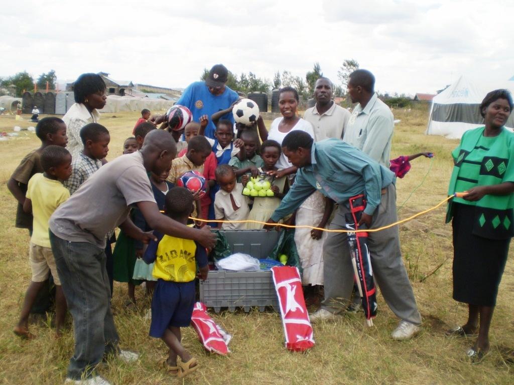 Crowd explore a teachers box, in Kenya