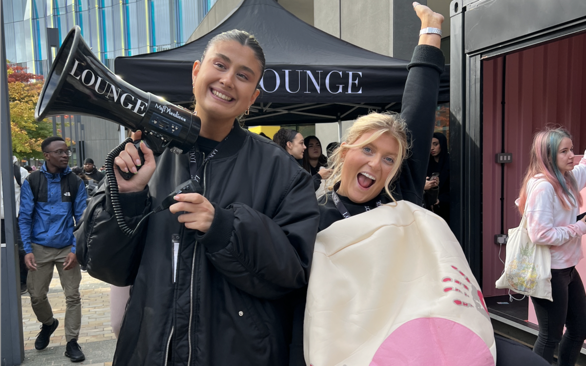 Lounge representatives with a loudspeaker and a big fake boob.
