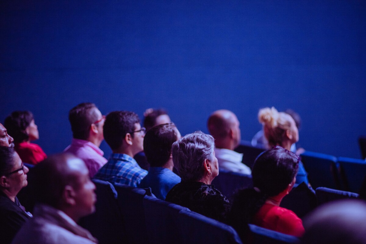 an audience in a darkened room