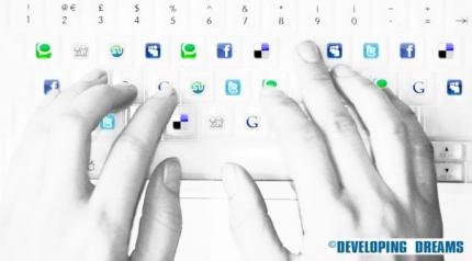 Typing on a keyboard with social media icons. Photo: Kati Byrne, DevelopingDreams.com