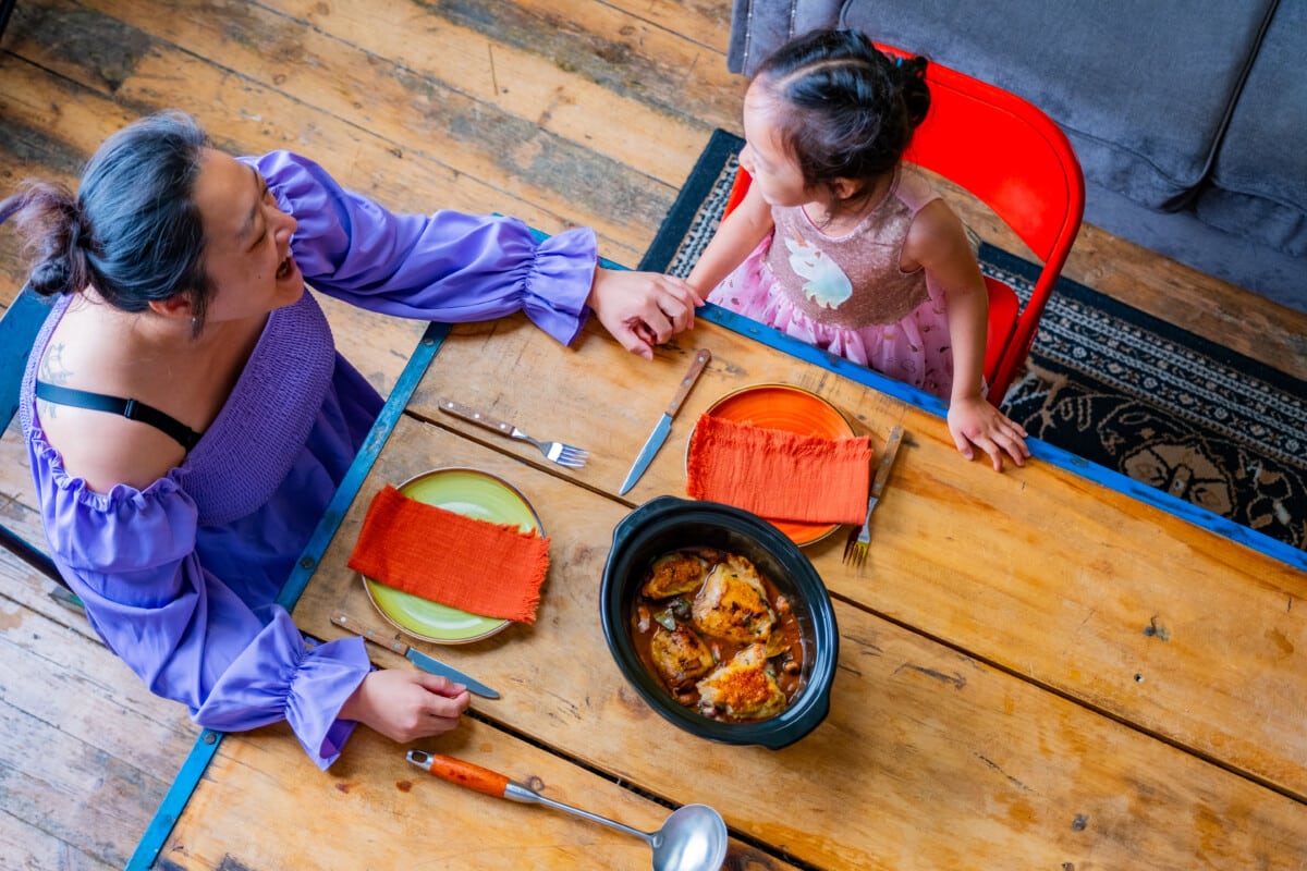 A shot looking down on a mum and child about to eat a meal - supported by Home-Start