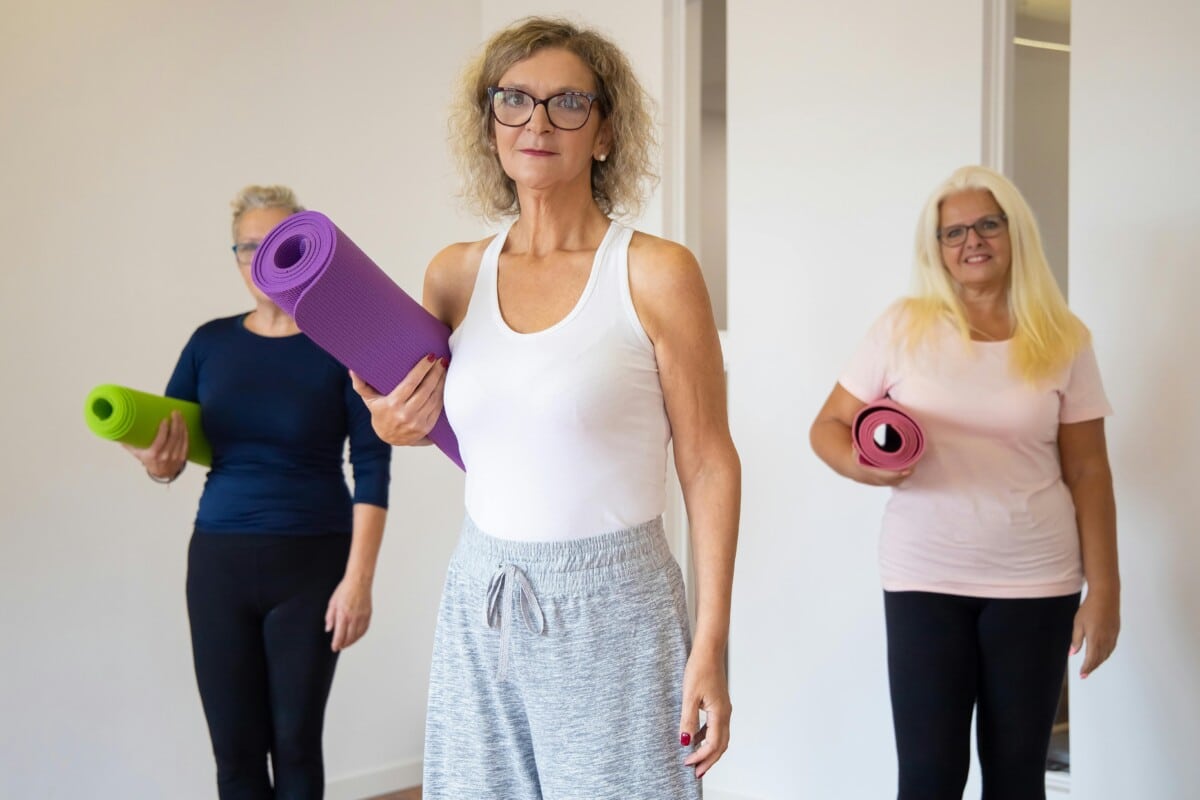 Women holding yoga mats